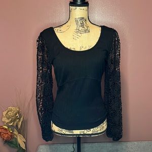 Woman’s size large black top. Lace sleeves with elastic at wrist